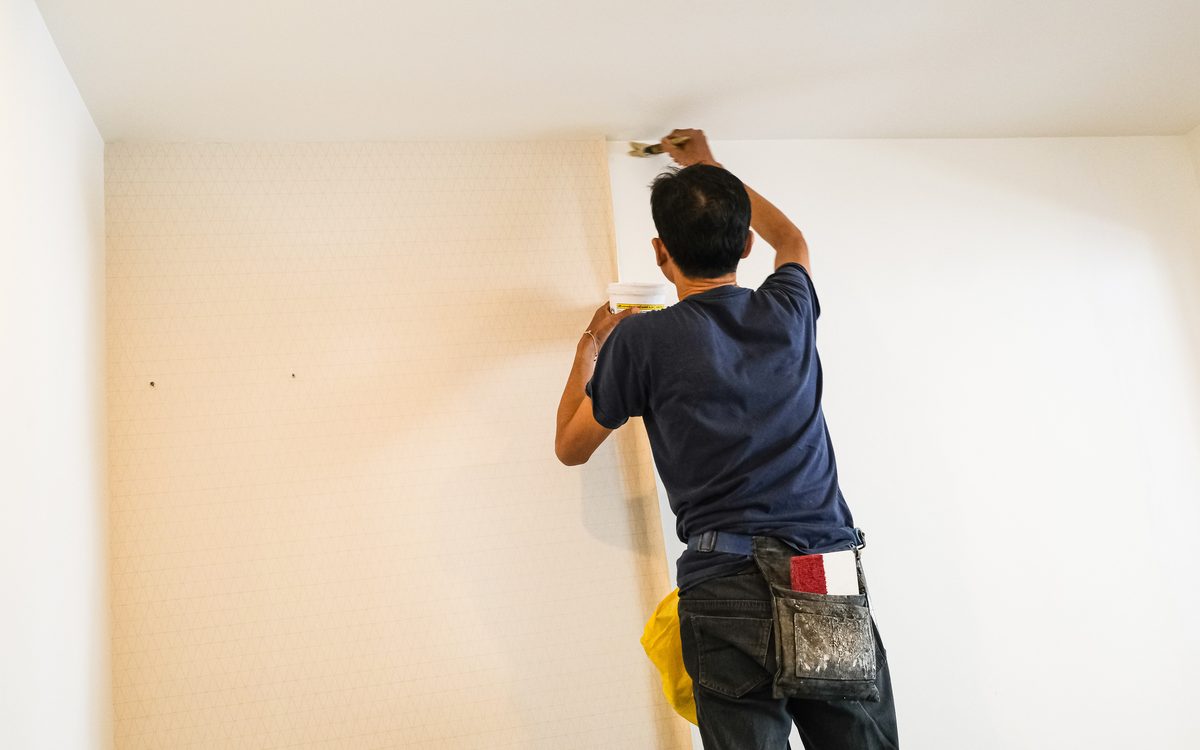 An installer hanging custom-printed wall covering